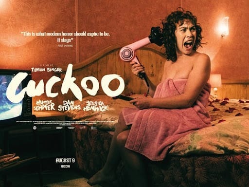 A promotional poster for Cuckoo featuring a woman in a towel sitting on a bed blowdrying her hair and screaming