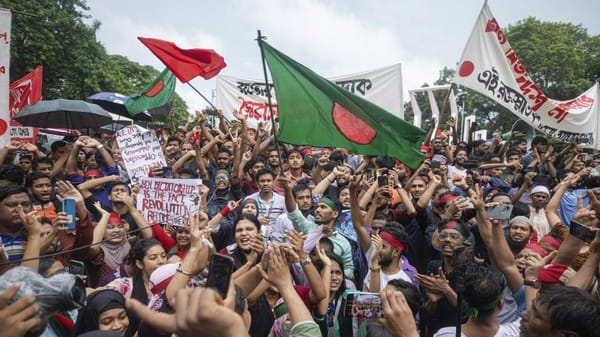 A crowd celebrates in Dhaka after the overthrow of Sheikh Hasina